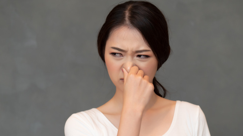 woman pinching her nose