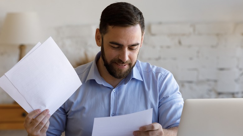 Man reading loan closing documents