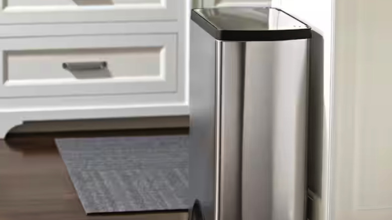 Simple Human rectangular trash can at the end of a counter in a kitchen