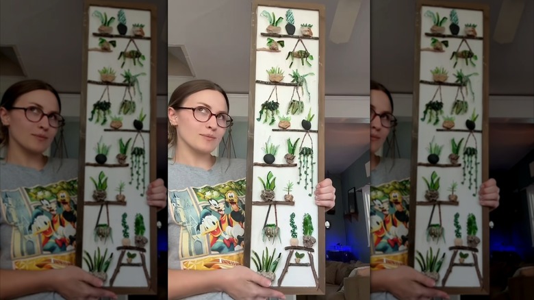 Screenshot of Instagram reel of a woman holding up homemade art made of broken glass.