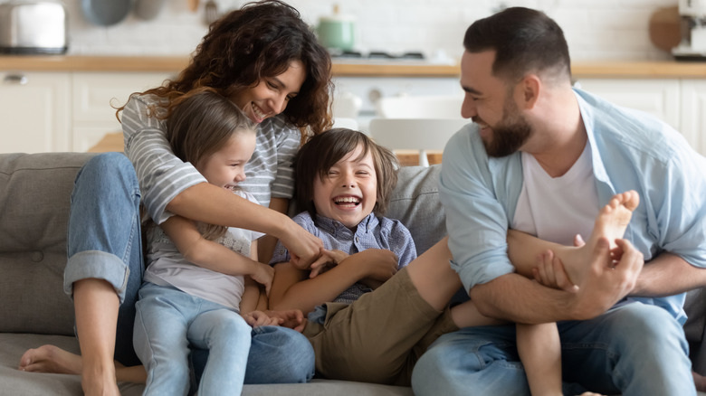 family laughing on a couch