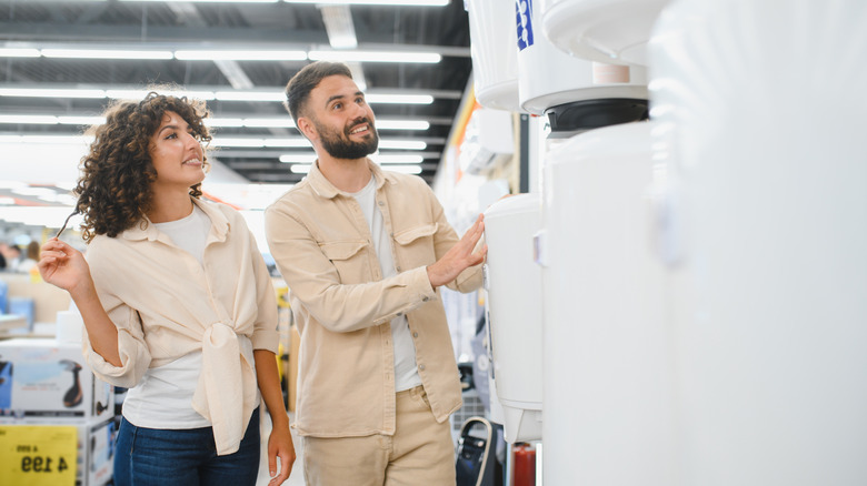 Couple looking at water heaters in a store