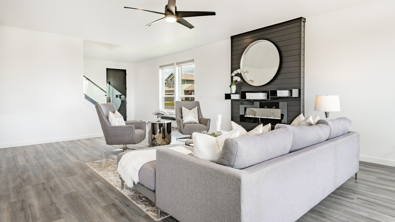 living room with white walls and gray vinyl floors and gray furniture