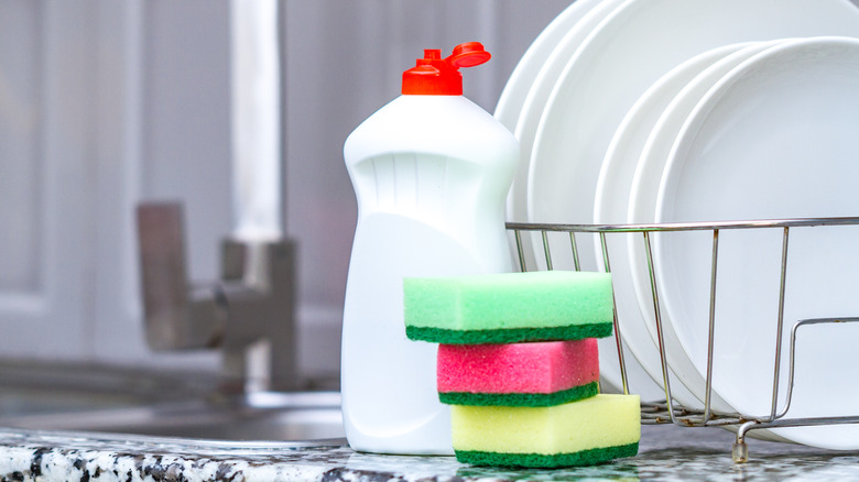 bottle of dish soap sitting by sink