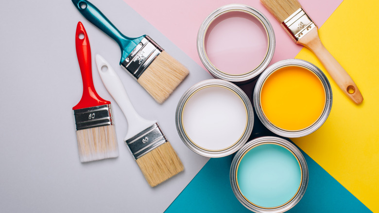cans of paint and paint brushes