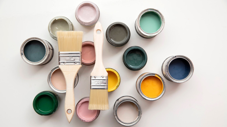cans of paint and paint brushes