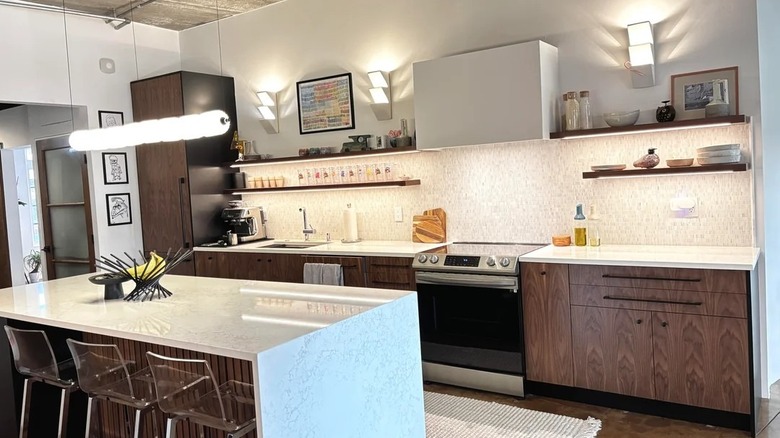 Industrial-style loft apartment with dark cabinets and kitchen island