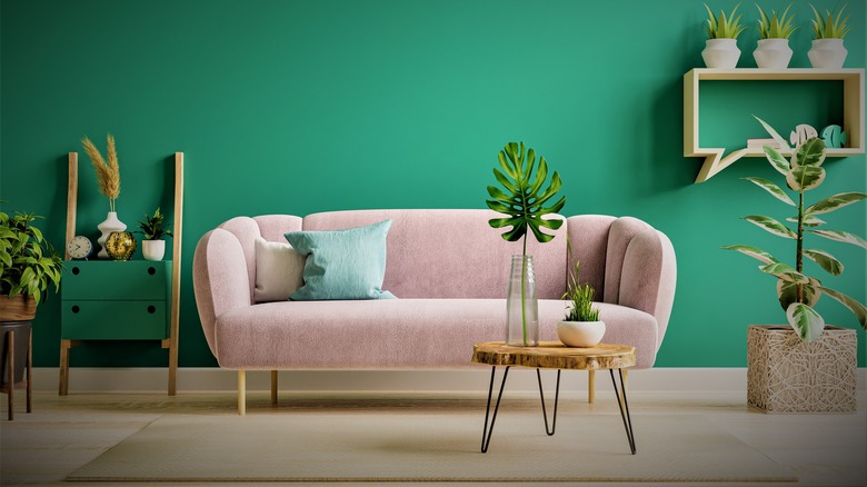 Pink couch in green room