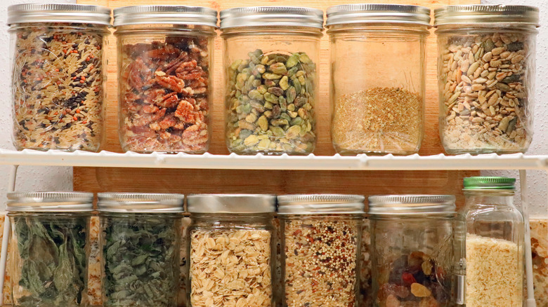 Two shelves of mason jars storing dried food items