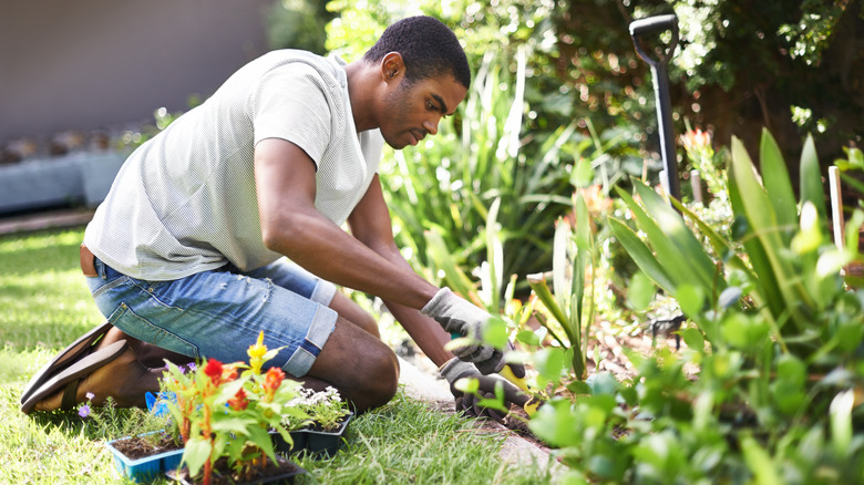 Man digging in flower garden