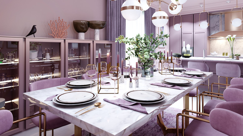 Lilac color dining room in trendy art deco style with modern furniture, served table, and chairs