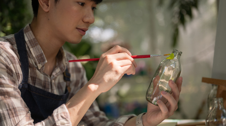 Man painting a glass vase