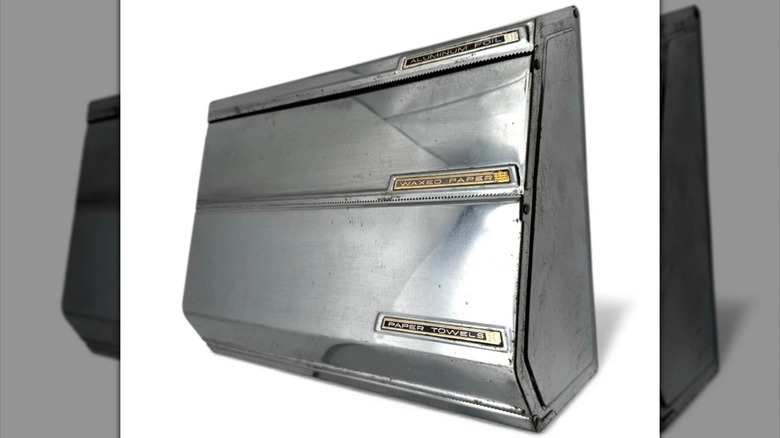 Vintage foil and paper dispenser on white background