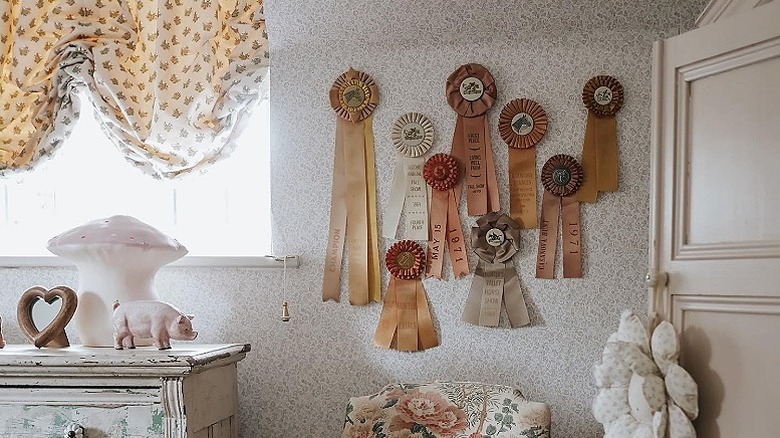 A collection of prize ribbons hanging on a wall in a bedroom