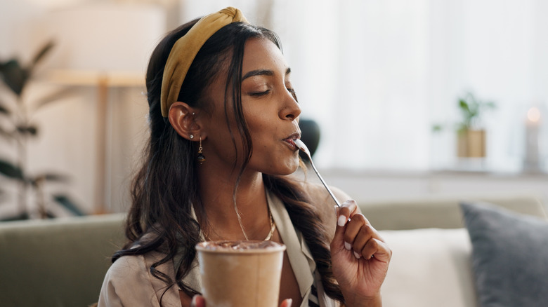 Woman taking a bite of frozen yogurt