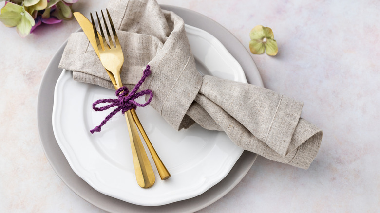 Gold silverware arranged on a plate