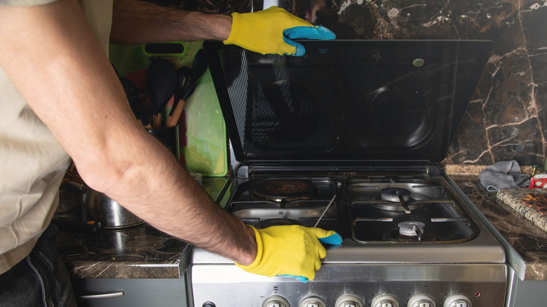 professional looking at gas oven