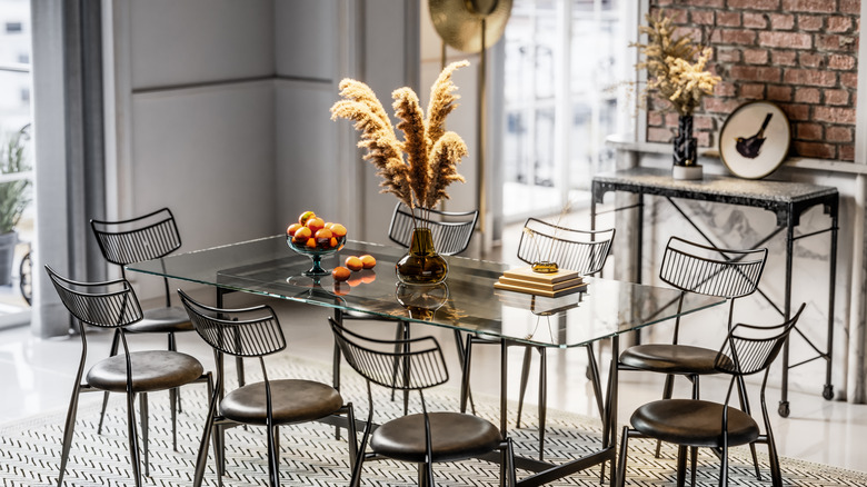 A dining room table sounded by sleek painted metal chairs