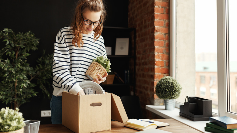 Woman packing desk in box