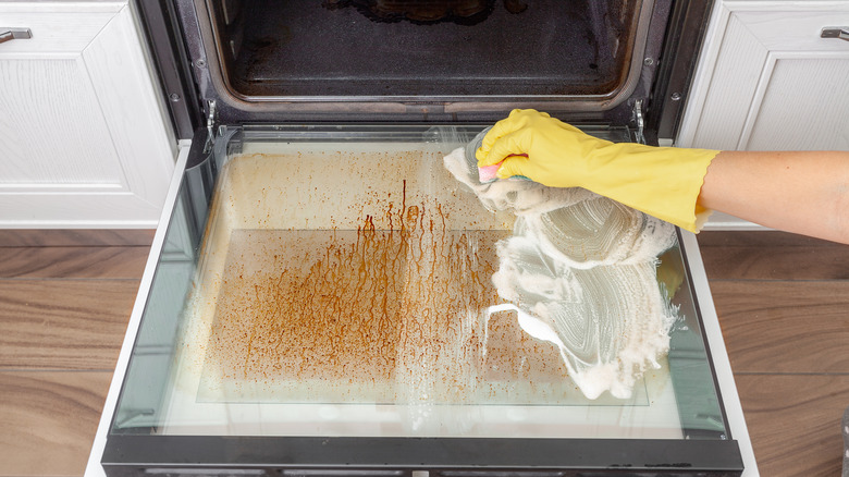 Person cleaning oven