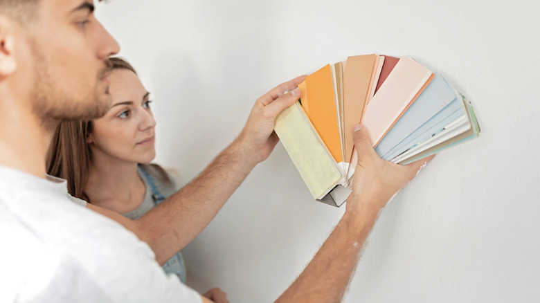 Couple checking paint samples