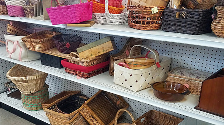 Assorted wicker baskets on the shelves of a thrift store.