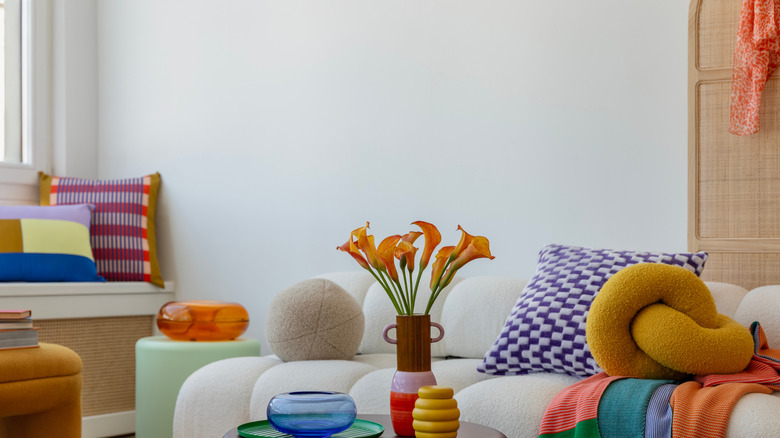Bright and bold living room with flowers cushions and colorful throws