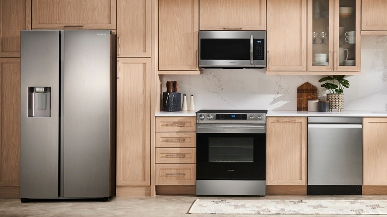 Samsung side-by-side refrigerator in a modern wood-panelled kitchen