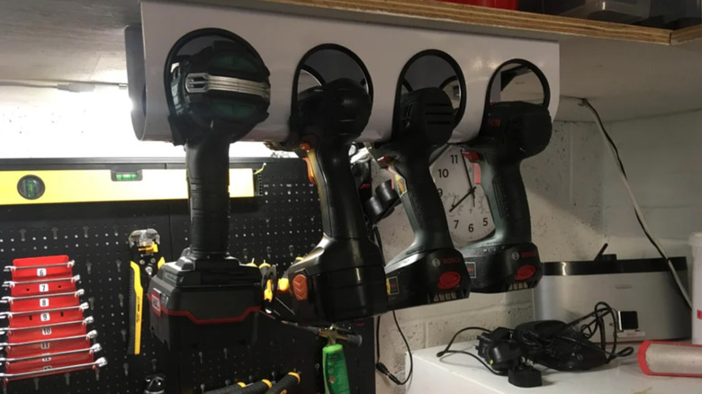 Four drills sitting in a wine rack
