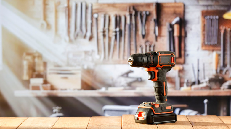 Drill sitting on a work bench in garage