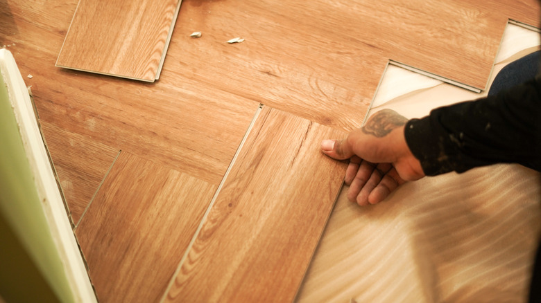 person laying wood floors in a pattern
