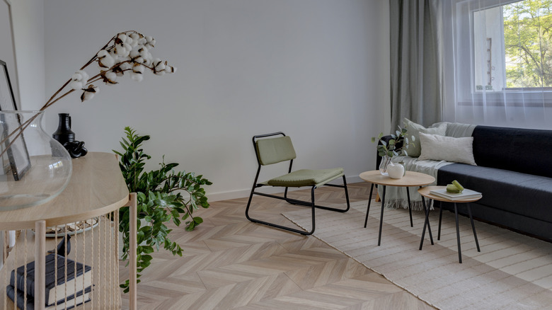 Modern living room furniture with herringbone wood floors.