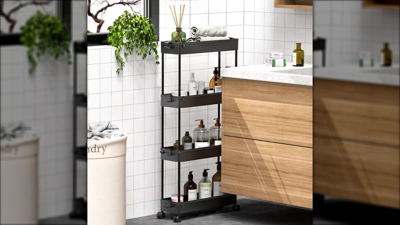 A slim plastic shelf with bathroom essentials next to a vanity.