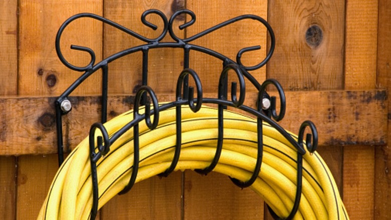 A decorative metal hose hanger that could be used indoors