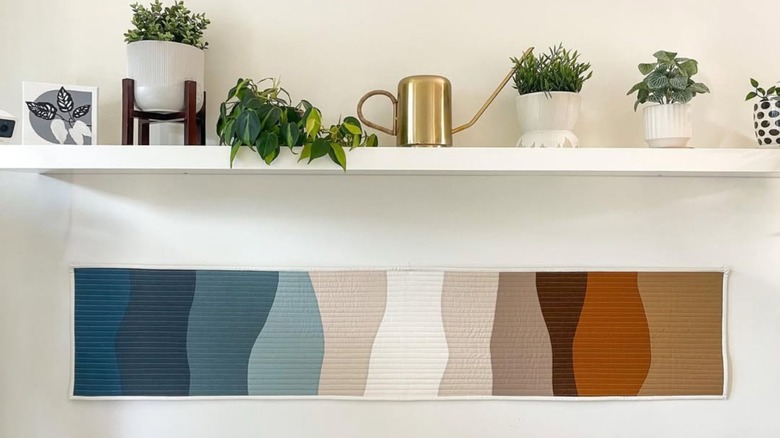 A multicolored table runner hanging on the wall