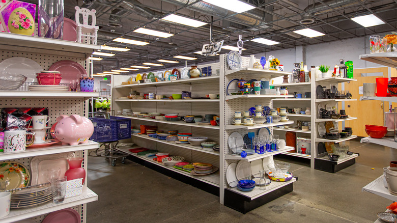 Aisles at a thrift store with kitchenware and home goods