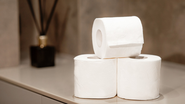 toilet paper rolls stacked on counter