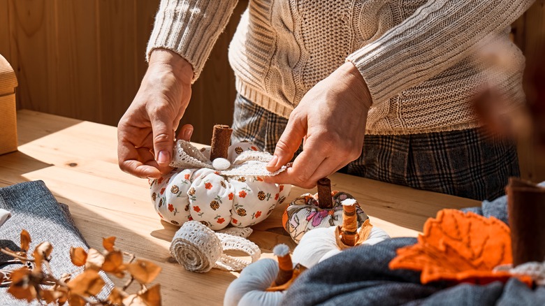 person making pumpkins with fabric