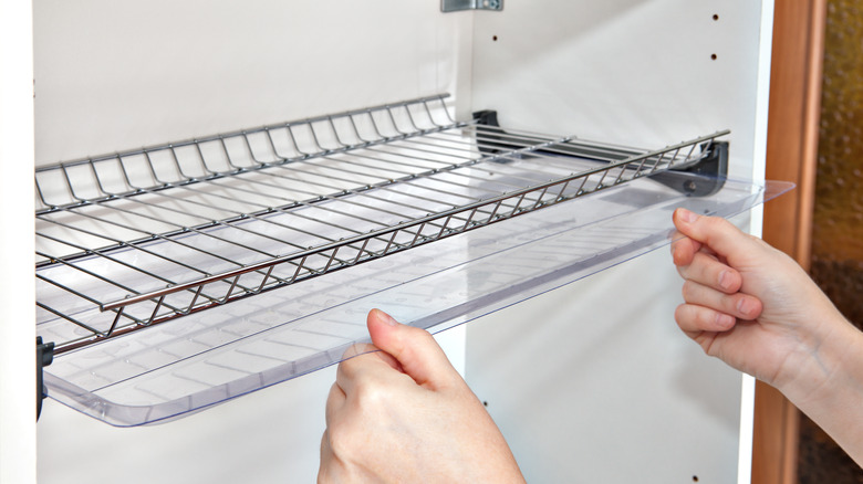 Man installing wire shelving