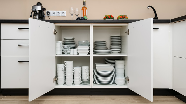 Open cabinet with dishes inside