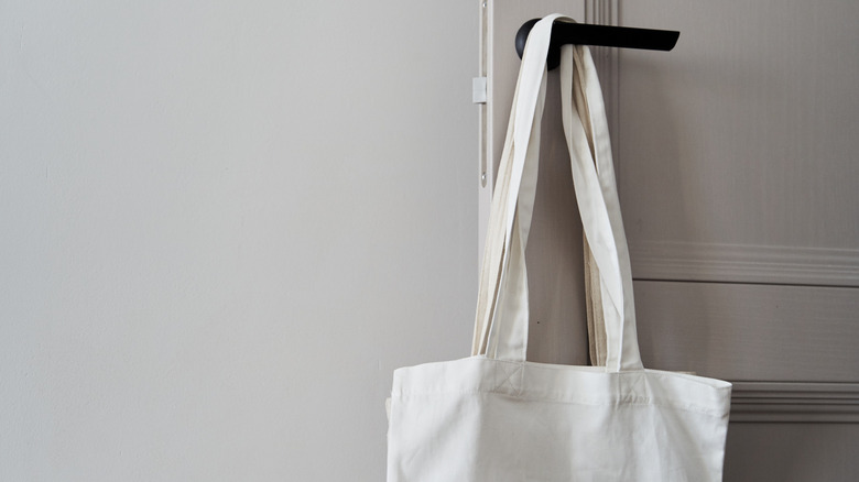 White canvas bag on door handle