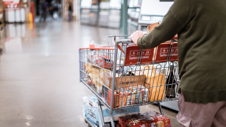 man pushing cart in costco 