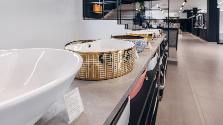 Variety of bathroom sinks in a showroom.
