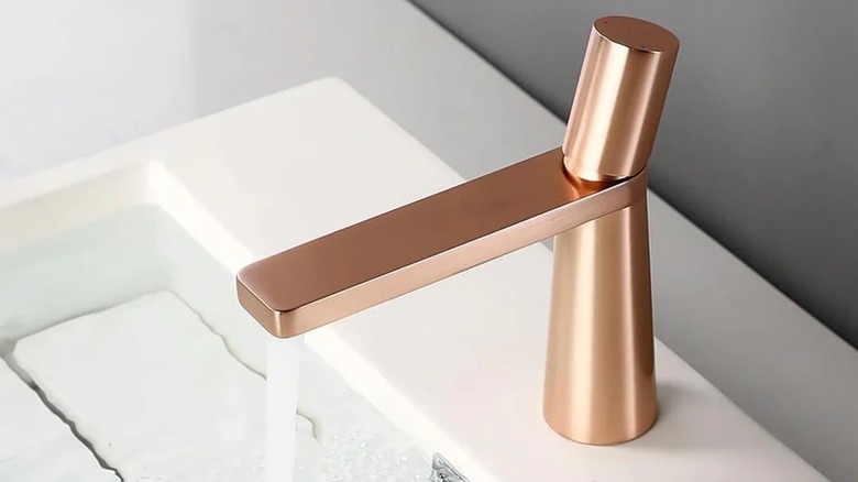 rose gold sink faucet with running water