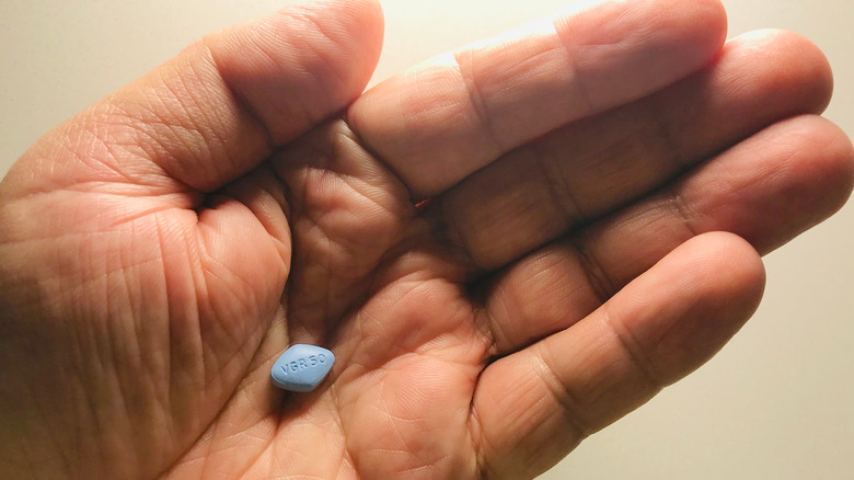 hand holding Viagra pill