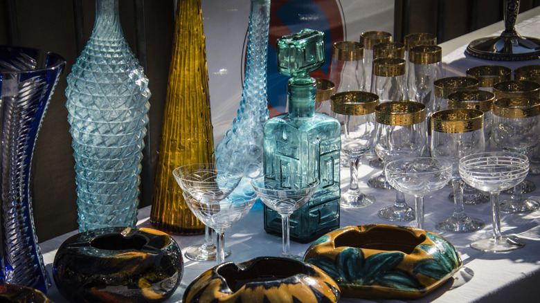 multiple antique glassware pieces at a garage sale