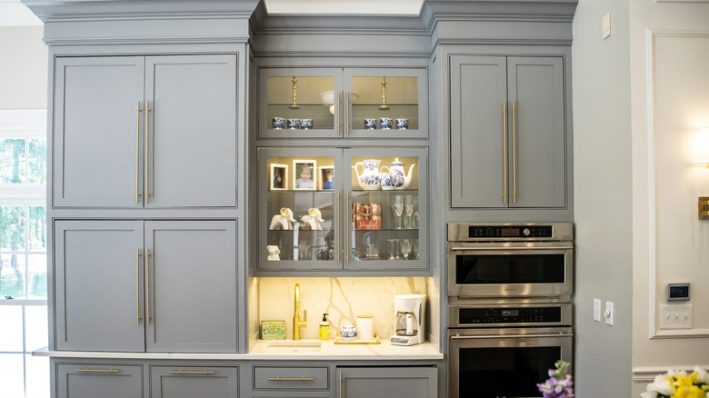 Kitchen with two glass cabinet display cases featuring internal lighting