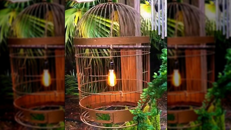 A large copper-painted bird cage upcycled into an outdoor light