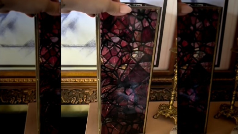 A thrifted lantern covered in faux stained glass window cling.