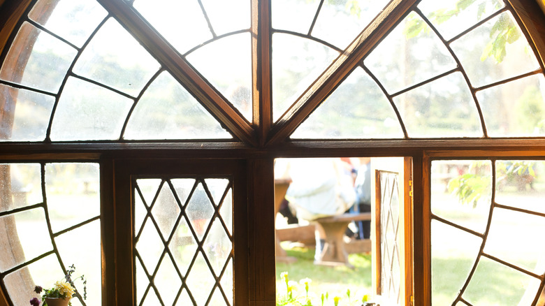 One window is open in a unique circular window frame